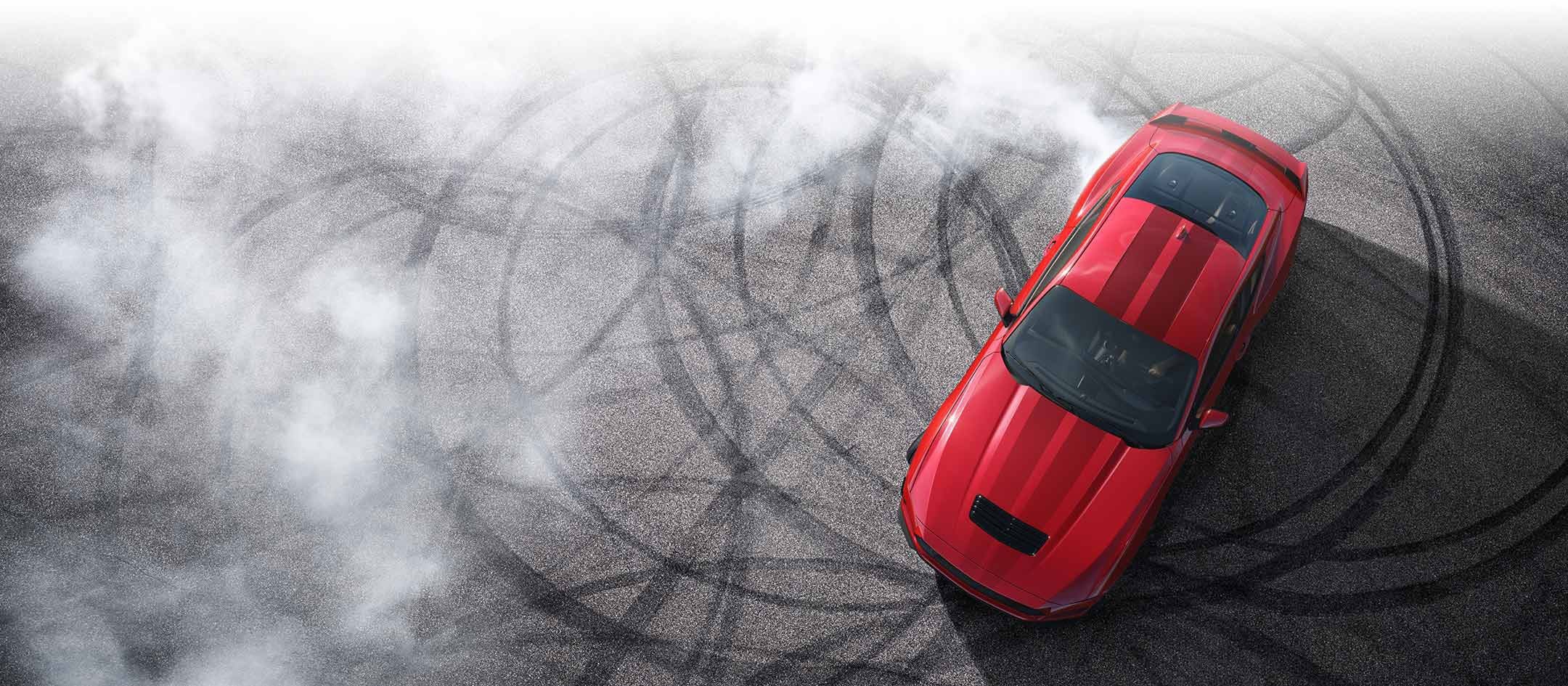 Overhead view of a 2024 Ford Mustang® model with tire tracks on pavement | Roland Rich Ford, Inc. in Delavan IL