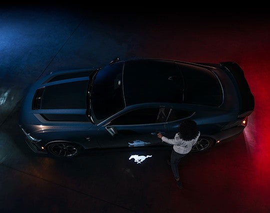 2024 Ford Mustang® Dark Horse™ model with a driver approaching the vehicle | Roland Rich Ford, Inc. in Delavan IL