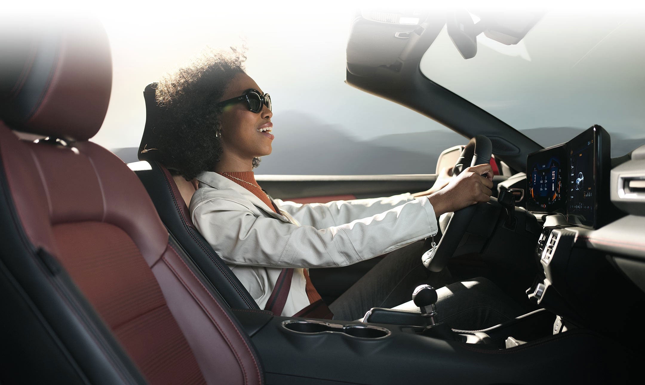 Person sitting in the driver’s seat of a 2024 Ford Mustang® convertible | Roland Rich Ford, Inc. in Delavan IL