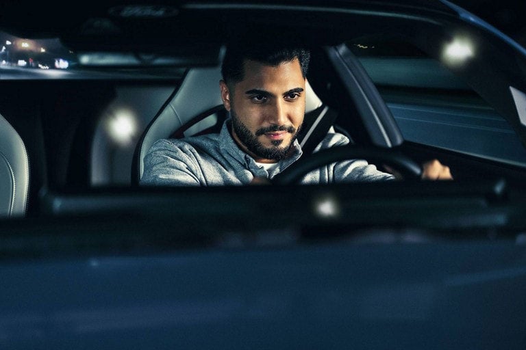 Person sitting in the driver’s seat of a parked 2024 Ford Mustang® coupe | Roland Rich Ford, Inc. in Delavan IL